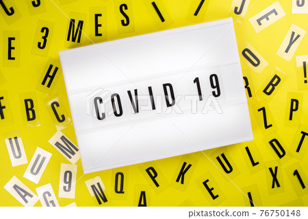 Lightbox with text COVID 19 on yellow background with letters, coronavirus news Lightbox with text COVID 19 on yellow background with letters, coronavirus news 76750148