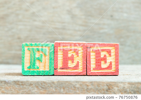 Color alphabet letter block in word fee on wood background Color alphabet letter block in word fee on wood background 76750876