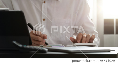 Close up of man using calculator. Serious office worker prepare financial report. Professional accountant. 76751026