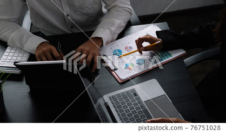 Two business teamwork calculating a valuation in workplace. 76751028