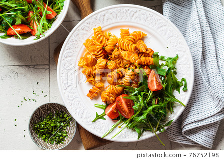 Baked pasta with chicken and cheese on white plate, gray background. Italian cuisine concept. Baked pasta with chicken and cheese on white plate, gray background. Italian cuisine concept. 76752198