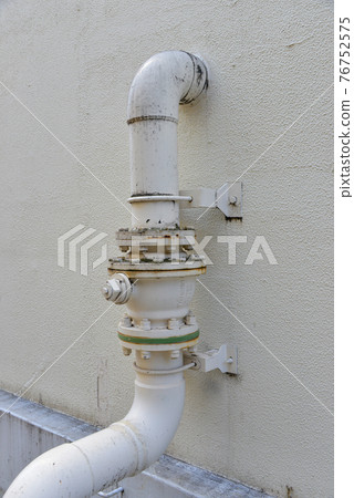 Water pipe on the wall of the building Water pipe on the wall of the building 76752575