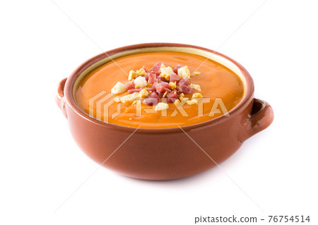 Typical Spanish salmorejo cream with ham and egg isolated on white background Typical Spanish salmorejo cream with ham and egg isolated on white background 76754514