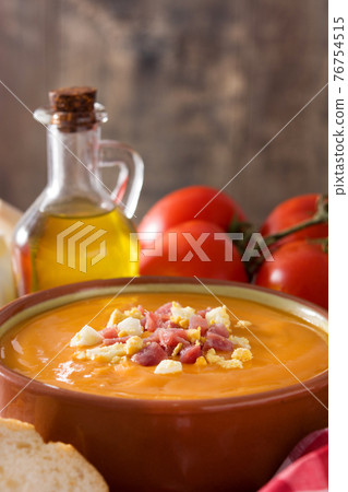 Typical Spanish salmorejo cream with ham and egg on wooden table Typical Spanish salmorejo cream with ham and egg on wooden table 76754515