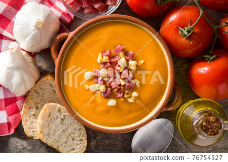 Typical Spanish salmorejo cream with ham and egg on wooden table Typical Spanish salmorejo cream with ham and egg on wooden table 76754527