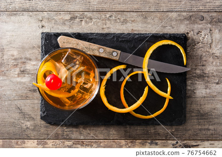 Old fashioned cocktail with orange and cherry 76754662