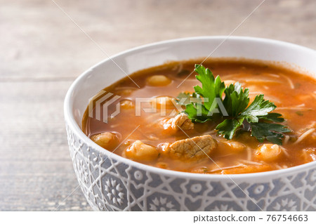 Harira soup in bowl on wooden table 76754663