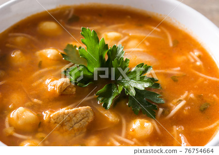 Harira soup in bowl on wooden table Harira soup in bowl on wooden table 76754664