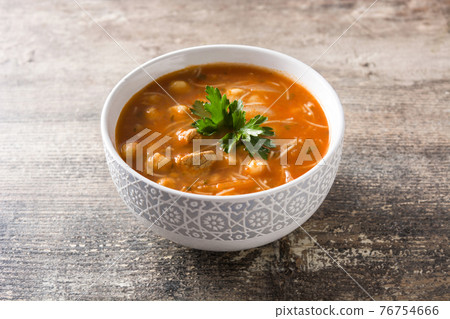 Harira soup in bowl on wooden table 76754666