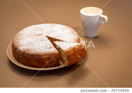 An ancient Roman cake made of almonds and dry bread with fresh cappuccino  76754939