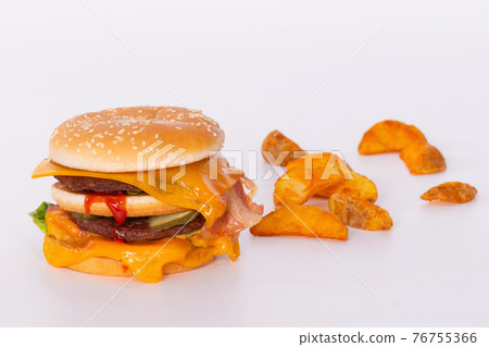 Delicious burger with melted cheese and fried potato slices Delicious burger with melted cheese and fried potato slices 76755366