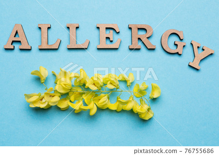 The inscription is alloted from letters on a blue background, below is a yellow inflorescence, a concept 76755686