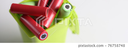 Electronic batteries lying in plastic toy container closeup Electronic batteries lying in plastic toy container closeup 76758748