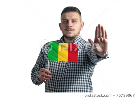 White guy holding a flag of Mali and with a serious face shows a hand stop sign isolated on a white background White guy holding a flag of Mali and with a serious face shows a hand stop sign isolated on a white background 76759067
