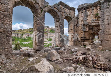 Tlos ruins, ancient Lycian hilltop citadel in  Turkey. View of the Acropolis through the arches of Roman baths. 76759215