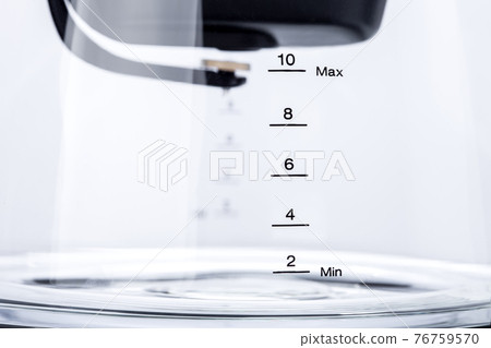 glass transparent flask for drip coffee maker with valve for brewing a drink, kitchen household appliances object with measuring scale close up isolated on white background. 76759570