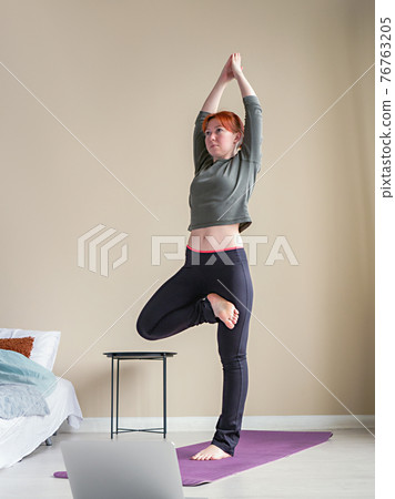 Red hair woman practicing yoga asanas. Yoga Red hair woman practicing yoga asanas. Yoga 76763205