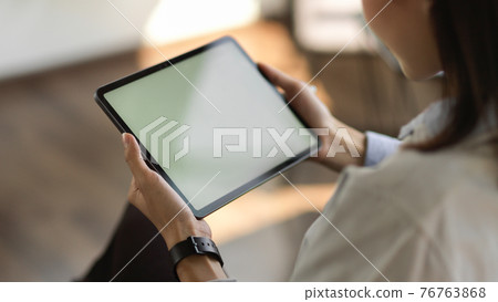 Cropped shot of young female holding mock up blank screen digital tablet Cropped shot of young female holding mock up blank screen digital tablet 76763868