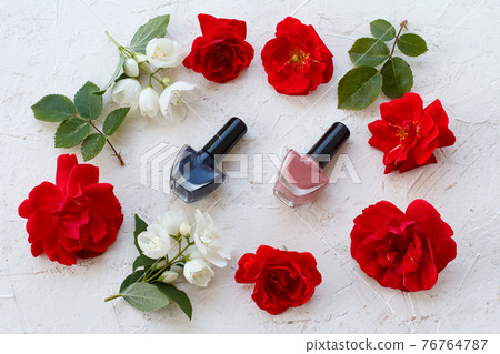 Woman cosmetics with flowers on a white background. Woman cosmetics with flowers on a white background. 76764787