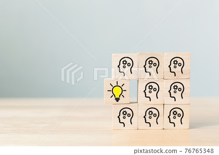 Concept creative idea and innovation. Wooden cube block with head human symbol and light bulb icon 76765348