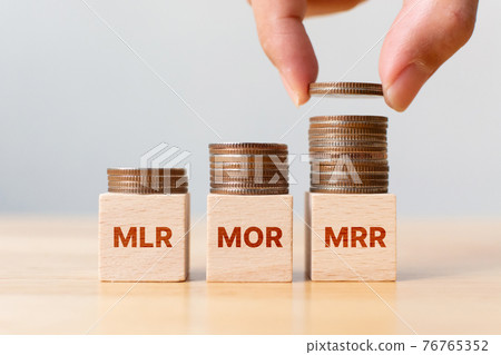 Interest rate mortgage property investment MLR, MOR, MRR. Coin stack step on wooden block Interest rate mortgage property investment MLR, MOR, MRR. Coin stack step on wooden block 76765352