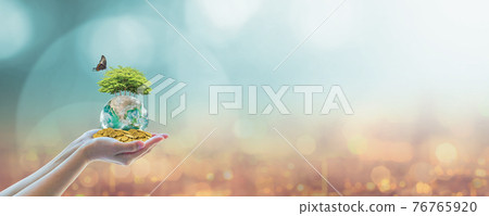 Sustainable global business investment in environment, social, governance (ESG) and CSR concept in clean industry with volunteer hands holding world green tree. Element of the image furnished by NASA. 76765920