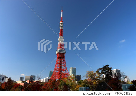 Iconic Tokyo Tower as seen from Shiba Koen (Shiba Park) against a blue sky Iconic Tokyo Tower as seen from Shiba Koen (Shiba Park) against a blue sky 76765953