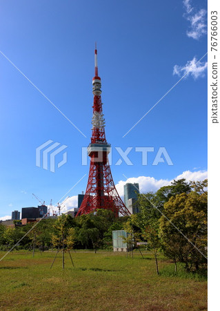 Iconic Tokyo Tower as seen from Shiba Koen (Shiba Park) against a blue sky Iconic Tokyo Tower as seen from Shiba Koen (Shiba Park) against a blue sky 76766003