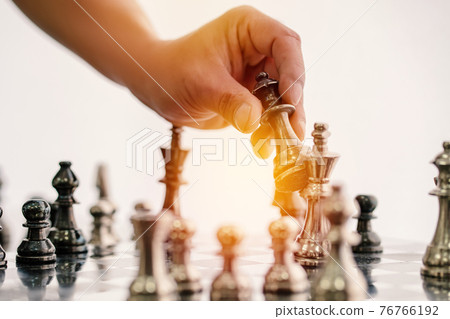 hand of businessman moving chess board game in competition success play hand of businessman moving chess board game in competition success play 76766192