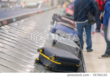 Suitcase or luggage with conveyor belt in the airport 76766193
