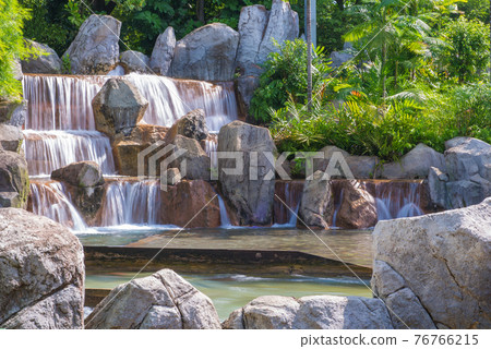 landscape of beautiful Artificial waterfall in garden at the public park landscape of beautiful Artificial waterfall in garden at the public park 76766215