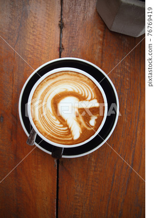 Top view of coffee in cup on wooden vintage table 76769419