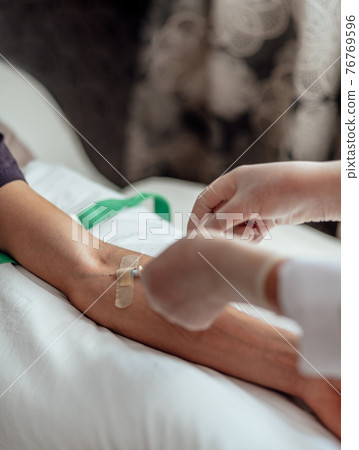 close up of doctor giving an injection to Man, getting vaccinated, coronavirus, covid-19 and vaccination concept. 76769596