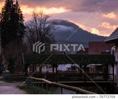 Beautiful view on the sunset in a small town Beautiful view on the sunset in a small town 76772709