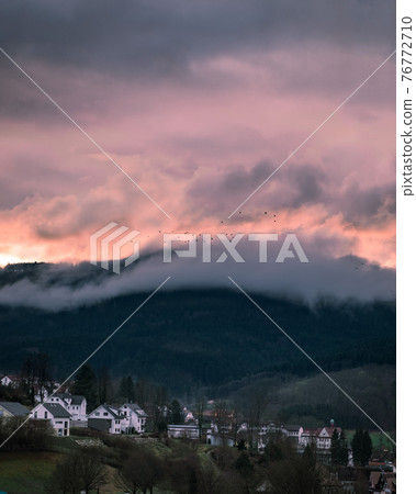 Beautiful view of the sunset in a small town Beautiful view of the sunset in a small town 76772710