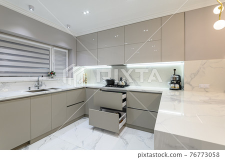 Open drawers at modern white kitchen furniture 76773058
