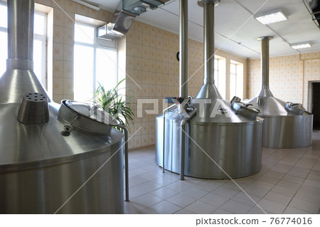 Large metal tanks for brewing beer in a beer factory 76774016