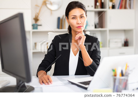 Portrait of successful business woman in office interior 76774364