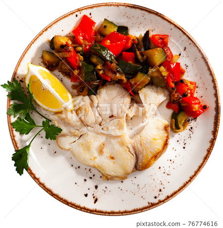 Roasted blue shark steak with vegetable saute, lemon and greens Roasted blue shark steak with vegetable saute, lemon and greens 76774616