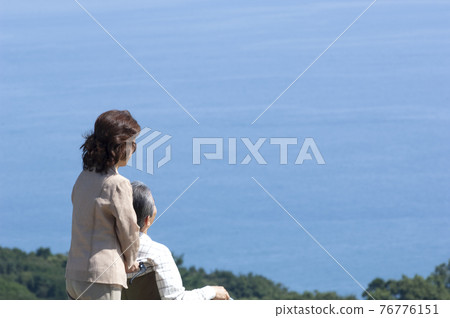 A couple taking a walk in a wheelchair 76776151