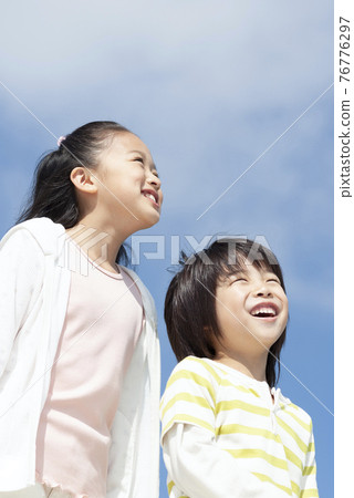 A smiling girl and a boy 76776297