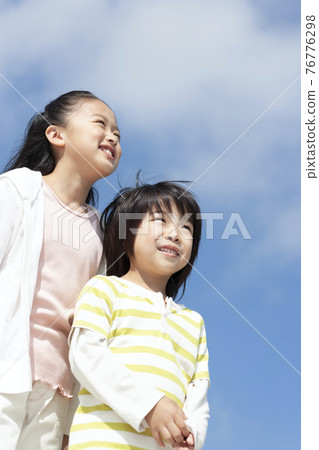 A smiling girl and a boy 76776298