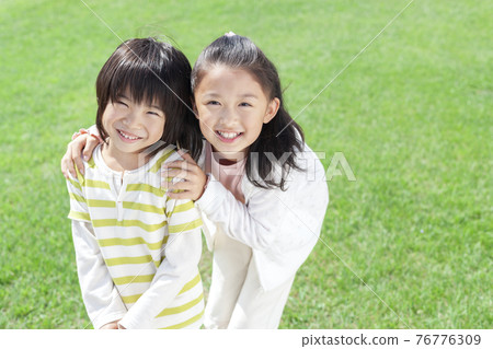 A smiling girl and a boy 76776309