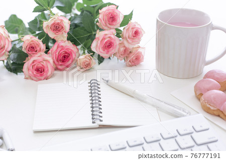 Pink office concept roses, keyboard and drinks 76777191