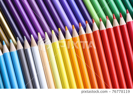 Many sharp wooden multicolored pencils background closeup 76778119