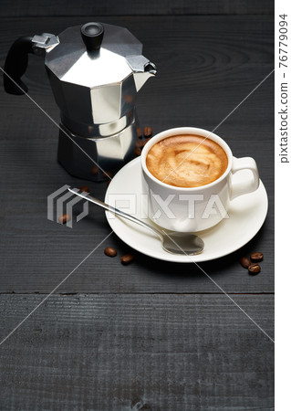 Cup of espresso coffee and mocha coffee maker on dark wooden background Cup of espresso coffee and mocha coffee maker on dark wooden background 76779094
