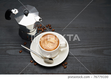Cup of espresso coffee and mocha coffee maker on dark wooden background Cup of espresso coffee and mocha coffee maker on dark wooden background 76779100