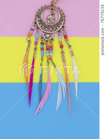 Ethnic decorations on colored sheets of paper. 76779238