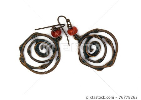 Ethnic jewelry on a white background. Round Metal Earrings Ethnic jewelry on a white background. Round Metal Earrings 76779262