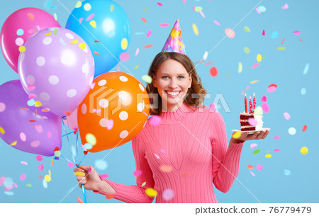 Cheerful woman with balloons and birthday cake under confetti Cheerful woman with balloons and birthday cake under confetti 76779479